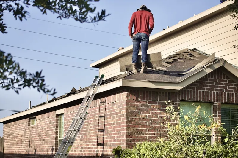 Professional roofer working on a residential roof in Olney Estates